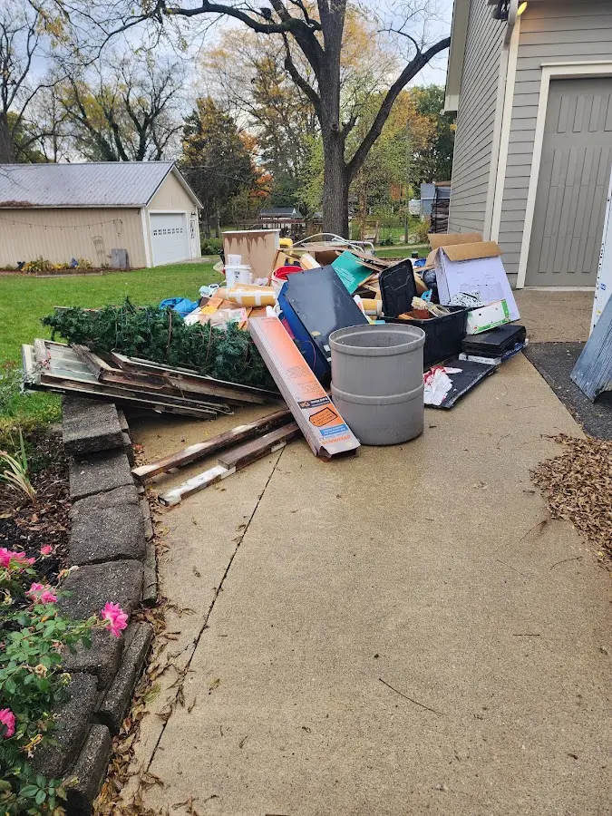 Dumpster being loaded with debris for Estate Cleanout Dumpster Rental in Broken Bow
